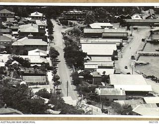 PORT MORESBY, NEW GUINEA. 1943-12-29. LOOKING UP PORT ROAD, THE MAIN STREET OF THE TOWN TOWARDS THE NAVAL WORKSHOPS. STANLEY ESPLANADE IS THE ROAD ALONG THE WATER-FRONT