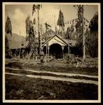 Man standing outside the Department of Land and Mines building after volcanic eruption, Rabaul, 1937