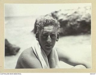 KILIGIA, NEW GUINEA. 1944-03-20. A BARE-CHESTED MR PAUL BECKER OF THE AUSTRALIAN PUBLIC RELATIONS FIELD UNIT