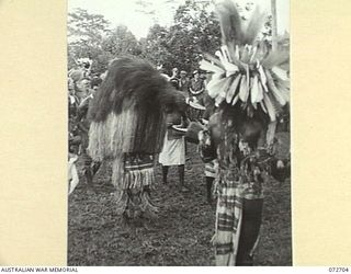 HIGITURA, NEW GUINEA. 1944-04-27. NATIVES PERFORMING A CASSOWARY DANCE DURING A CEREMONY HELD TO HONOUR THE VISIT OF THE HONOURABLE E.J. WARD, MINISTER FOR EXTERNAL TERRITORIES IN THE AUSTRALIAN ..