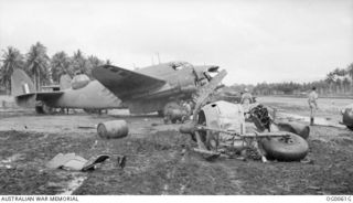 MILNE BAY, PAPUA. C. 1942-10. A DAMAGED HUDSON BOMBER AIRCRAFT OF NO. 6 SQUADRON RAAF WHICH HAD BEEN STRUCK BY A BEAUFIGHTER AIRCRAFT OF NO. 30 SQUADRON RAAF WHICH WAS ATTEMPTING TO LAND ON THE ..