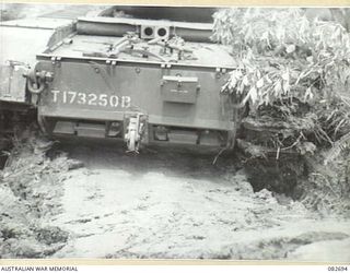 MADANG, NEW GUINEA. 1944-10-12. A CHURCHILL V TANK NEGOTIATING THICK MUD WHERE TWO MATILDA TANKS HAD BEEN PREVIOUSLY BOGGED. THE TANK IS ENGAGED IN TESTS AT HQ 4 ARMOURED BRIGADE