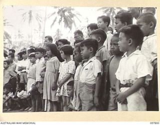 RATONGOR, NEW BRITAIN. 1945-10-10. A LINE OF SMALL CHILDREN AT THE CHINESE CIVILIAN CAMP ATTENDING THE GALA DAY HELD ON THE 34TH ANNIVERSARY OF THE COMING TO POWER OF THE CHINESE REPUBLIC ..