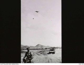 NEW GUINEA, 1942-08. A FRIENDLY 'PLANE PASSES OVER A BREN GUN CARRIER OF THE 39TH INFANTRY BATTALION, AUSTRALIAN MILITARY FORCES, WHILST ON MANOEUVRES IN NEW GUINEA