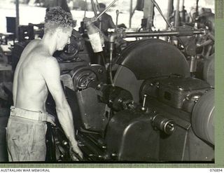 Lae, New Guinea. 1944-11-15. NX141327 Sergeant K. Weeber operating an universal grinder at the 2/7th Advanced Workshops, AIF