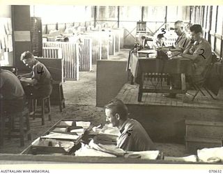 PORT MORESBY, PAPUA, 1944-02-26. THE REGISTRATION ROOM AT THE NEW GUINEA FORCE SIGNALS OFFICE, SHOWING THE WIRELESS GALLERY AT THE REAR OF THE PICTURE. THE OFFICE IS MANNED BY PERSONNEL OF THE 18TH ..