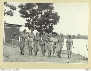 SOUTH ALEXISHAFEN, NEW GUINEA. 1944-08-08. SISTERS OF THE 111TH CASUALTY CLEARING STATION ENJOYING A WALK ALONG THE SHORES OF THE BAY IN THE COOL OF THE EVENING. IDENTIFIED PERSONNEL ARE:- WFX33605 ..