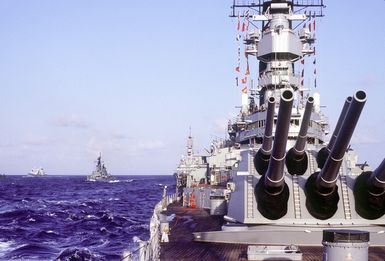 A close-up view of Mark 7 16-inch/50-caliber guns aboard the battleship USS MISSOURI (BB-63) as the vessel is underway with other ships of its battle group during exercise RIMPAC '90 near Hawaii