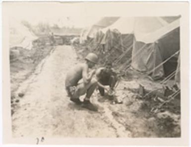 [Servicemen cleaning mess kits at military camp, Saipan]