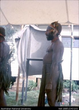 Man in traditional dress, lined up to vote