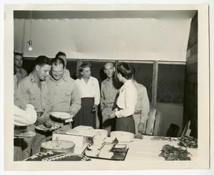 [Flight Nurses and Servicemen Serving Cake At Anniversary Party]