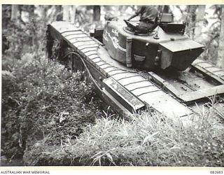 MADANG, NEW GUINEA. 1944-10-12. A CHURCHILL V TANK BOGGED AT A CREEK CROSSING DURING TESTS CONDUCTED AT HQ 4 ARMOURED BRIGADE