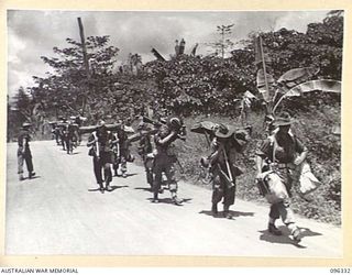 RABAUL, NEW BRITAIN, 1945-09-10. MEMBERS OF 29/46 INFANTRY BATTALION WALKING UP THE ROAD TOWARDS RABAUL. TROOPS OF 4 INFANTRY BRIGADE OCCUPIED THE RABAUL AREA FOLLOWING THE SURRENDER OF THE ..