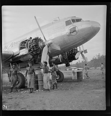 Qantas Empire Airways, aircraft being serviced as locals watch, Lae airfield, Papua New Guinea