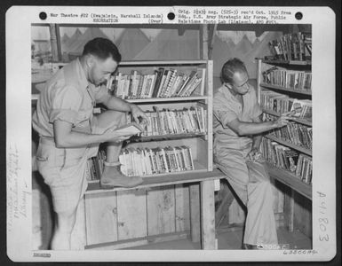 Gi'S Brows Through Some Of The 500 Odd Paper-Backed Books At The 87Th Airdrome Squadron Library On Kwajalein, Marshall Islands. 23 April 1944. (U.S. Air Force Number 63500AC)