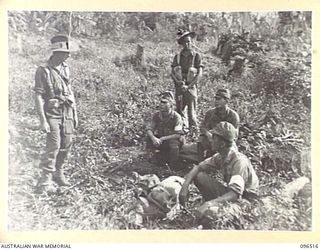 RABAUL, NEW BRITAIN, 1945-09-11. LIEUTENANT E.B. WILLIAMS, 29/46 INFANTRY BATTALION (1), WATCHES JAPANESE PERSONNEL BROUGHT IN BY MEMBERS OF B COMPANY DURING THE BATTALION'S SECURITY OPERATIONS ..