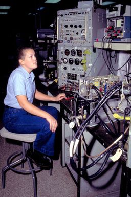 Aviation Electronics Technician AIRMAN Kim Ksenzulak tests a tactical air navigation system receiver/transmitter at the Aircraft Intermediate Maintenance Department