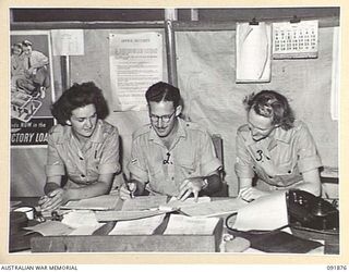 LAE, NEW GUINEA, 1945-05-16. MEMBERS OF THE AUSTRALIAN WOMEN'S ARMY SERVICE RECEIVING TUITION IN THEIR NEW JOBS AT GENERAL BRANCH AND INTELLIGENCE, HEADQUARTERS LAE BASE SUB-AREA. AUSTRALIAN ..
