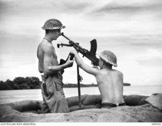 GODOWA, NEW GUINEA. 1943-11-05. NX24933 GUNNER A. C. THYNNE OF WAHROONGA, NSW, (LEFT) AND NX22729 GUNNER B. B. BRUSH OF SYDNEY, NSW, (RIGHT), BOTH OF C TROOP, 2/3RD AUSTRALIAN LIGHT ANTI-AIRCRAFT ..