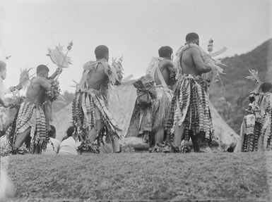 [Pacific island men performing outdoors]