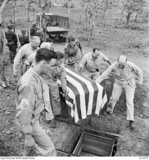 Funeral of New York Times war correspondent Byron Darnton, at the military cemetery at Port Moresby. Pall-bearers were war correspondents. Four were American, one English, one Australian. Left to ..