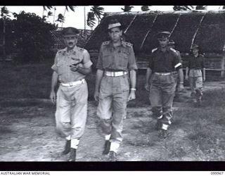 RABAUL, NEW BRITAIN, 1946-04-05. MAJOR-GENERAL B.M. MORRIS, GENERAL OFFICER COMMANDING 8 MILITARY DISTRICT (1), AND MEMBERS OF THE OFFICIAL PARTY INSPECTING AUSTRALIAN ARMY EDUCATION SERVICE ..