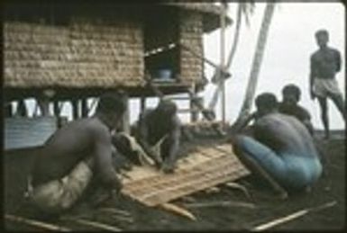 Group of men weaving