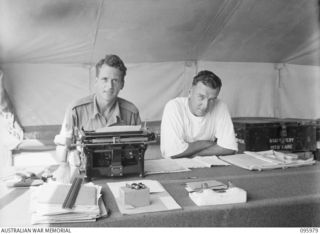 CAPE WOM, WEWAK AREA, NEW GUINEA. 1945-09-01. STAFF SERGEANT M.S. CLARKE (1) AND CORPORAL J.D. HENDERSON (2), MEMBERS OF THE ORDERLY ROOM STAFF, 2/4 DENTAL UNIT ATTACHED HEADQUARTERS 6 DIVISION