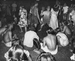 Crew members and locals at the village of Taiohae prepare to perform "loving pigs" dance, Marquesas Islands