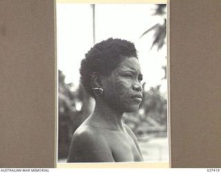 WANIGELA, NEW GUINEA. 1942-10. NATIVE WOMAN AT WANIGELA MISSION. NOTE THE UNIQUE FACIAL TATTOOING