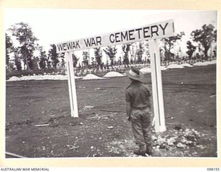 CAPE MOEM, NEW GUINEA. 1945-10-23. THE ENTRANCE TO THE WEWAK WAR CEMETERY. GRAVES ARE VISIBLE THROUGH THE ARCHWAY BOTH IN FOREGROUND AND BACKGROUND. THE CEMETERY IS MAINTAINED BY 7 WAR GRAVES UNIT ..