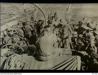 At Sea, off Papua. 1942-12-14. Members of the AIF preparing for disembarkation from HMAS Broome to go into action at Buna