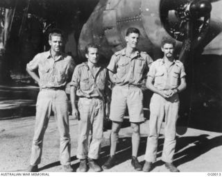 PORT MORESBY, PAPUA. C. 1943. RAAF AND US ARMY AIR CORPS WHO ARE FLYING TOGETHER AS THE CREW OF AN AMERICAN B25 MITCHELL BOMBER AIRCRAFT. CO-PILOT OF THIS CREW IS PILOT OFFICER ROYCE K. JOHNCO RAAF ..