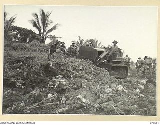 JACQUINOT BAY, NEW BRITAIN. 1944-11-04. A SAPPER OF HEADQUARTERS, 6TH INFANTRY BRIGADE USING A BULLDOZER TO LEVEL OFF A SANDHILL AT THE UNIT BRIDGEHEAD