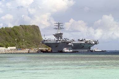 Port view of the US Navy (USN) Aircraft Carrier USS NIMITZ (CVN 68) arriving at Apra Harbor, Guam (GU). The Nimitz Carrier Strike Group is visiting Naval Base Guam (GU) for a scheduled port visit while on a regularly scheduled deployment in support of the Global War on Terrorism