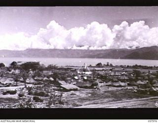 LAE, NEW GUINEA. 1943-10-04. SECTION PHOTOGRAPH OF THE WATERFRONT TAKEN FROM OBSERVATION HILL COVERS HANGAR ON LEFT AND PART OF THE AIRSTRIP. TO JOIN PHOTOGRAPHS NOS. 57973, 57974, 57975 AND 57977