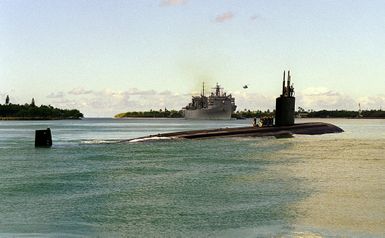 The crew of the nuclear powered attack submarine USS PASADENA (SSN 752) man the rail as the sub moves out of Pearl Harbor, passing two other Navy ships and an airborne helicopter, for sea exercises during RIMPAC '98