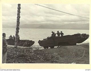 LAE, NEW GUINEA. 1944-03-30. DUKWS (LANDING CRAFT MECHANIZED), OF AMPHIBIOUS PLATOON, 151ST GENERAL TRANSPORT COMPANY, ENTERING WATER TO COMMENCE THE DAILY TASK OF UNLOADING STORES FROM SHIPS ..