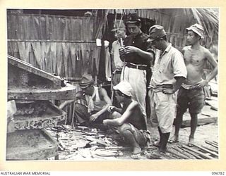 BUKA ISLAND, BOUGAINVILLE AREA, 1945-09-19. JAPANESE NAVAL TROOPS SORTING AND PLACING NAME TAGS ON KARI KARI DAGGERS IN READINESS FOR COLLECTION BY THE AUSTRALIAN SURRENDER PARTY FROM HQ 2 CORPS
