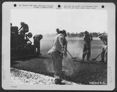 Men Of The 72Nd Sea Bees Spread Smoking Hot Asphalt On The Runway Which They Are Building For The 11Th Bomb Group At Agana Field On Guam, Marianas Islands. 10 October 19444. (U.S. Air Force Number 70544AC)