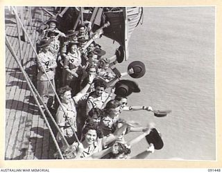 LAE, NEW GUINEA, 1945-05-07. AUSTRALIAN WOMEN'S ARMY SERVICE PERSONNEL WAVING TO TROOPS ON THE SHORE DURING DISEMBARKATION FROM THE MV DUNTROON. THEY ARE EN ROUTE TO THE AUSTRALIAN WOMEN'S ARMY ..