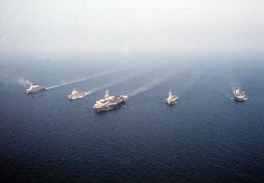 Ships from four nations sail in formation during the NATO Southern Region exercise DRAGON HAMMER '90. The ships are, from left: the British light aircraft carrier HMS INVINCIBLE (R-05), the Italian light aircraft carrier ITS GIUSEPPE GARIBALDI (C-551), the nuclear-powered aircraft carrier USS DWIGHT D. EISENHOWER (CVN 69), the Spanish aircraft carrier SPS PRINCIPE DE ASTURIAS (R-11) and the amphibious assault ship USS SAIPAN (LHA 2)