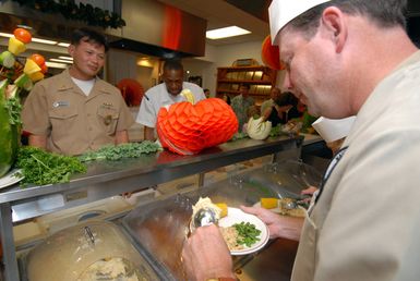 U.S. Navy CAPT. Taylor Skardon serves Thanksgiving dinner on Nov. 23, 2006, to patrons of the Silver Dolphin Bistro galley at Naval Station Pearl Harbor, Hawaii. The Bistro served a wide variety of menu items for Thanksgiving dinner, including turkey, stuffing and sweet potatoes. (U.S. Navy PHOTO by Mass Communication SPECIALIST 1ST Class James E. Foehl) (Released)