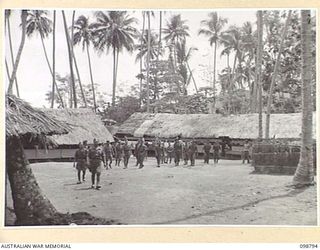 KERAVIA BAY, NEW BRITAIN. 1945-11-12. THE EXTERIOR VIEW OF THE ROYAL NETHERLANDS EAST INDIES ARMY CAMP, WHERE SOME 150 ROYAL NETHERLANDS EAST INDIES EX-PRISONERS OF WAR ARE AWAITING MOVEMENT TO ..