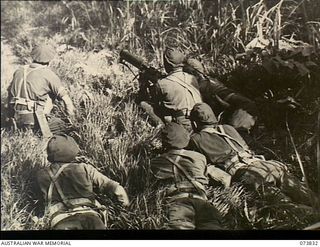 Karkar Island, New Guinea. 1944-06-04. A Vickers machine gun crew from the 37/52nd Infantry Battalion covering a track on the island