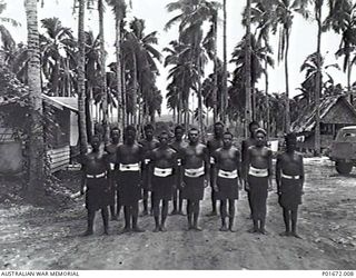 LUNGGA, GUADALCANAL, SOLOMON ISLANDS, 1944-02-29. A GROUP OF NATIVE HOUSEBOYS AND GARDENERS STANDING AT ATTENTION AT THE HEADQUARTERS CAMP OF THE DEPUTY SUPERVISING INTELLIGENCE OFFICER (DSIO), ..