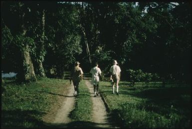 Dr Roy Scragg and others (walking away from the camera) at Kieta : Bougainville Island, Papua New Guinea, 1960 / Terence and Margaret Spencer