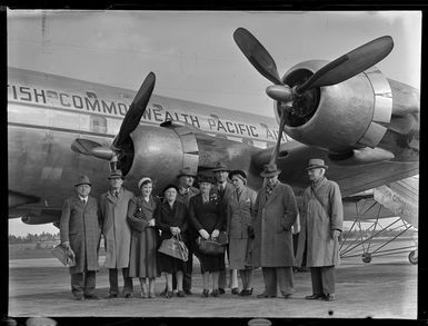 Group of people standing beside the British Commonwealth Pacific Airlines aircraft RMA Endeavour at Whenuapai