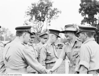 LAE AREA, NEW GUINEA, 1945-06-28. HIS ROYAL HIGHNESS, THE DUKE OF GLOUCESTER, GOVERNOR-GENERAL OF AUSTRALIA (5) BEING GREETED BY MAJ T.W. UPSON (1), DURING HIS VISIT TO THE ROYAL PAPUAN ..