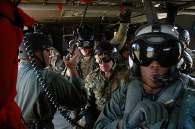 Royal Australian Navy (RAN) Sailors and US Navy (USN) Sailors aboard a USN MH-60S Sea Hawk helicopter form Helicopter Sea Combat Squadron 25 (HSC-25) prepare to conduct rappel training during a Helicopter Rope Suspension Technique (HRST) training exercise held at Polaris Point, Santa Rita Naval Base, Guam (GU), during the Annual Multi-national Explosive Ordnance Disposal (EOD) Exercise known as TRICARB 2006." The Exercise brings together EOD Units from the US, Australia and Singapore